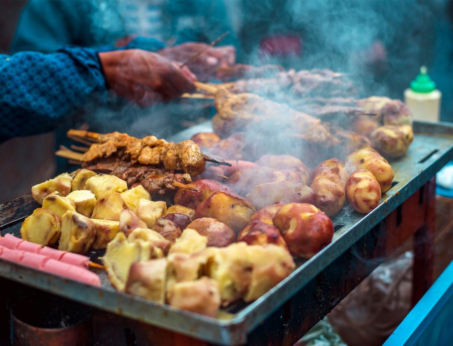 Street food vendor food on grill in Peru