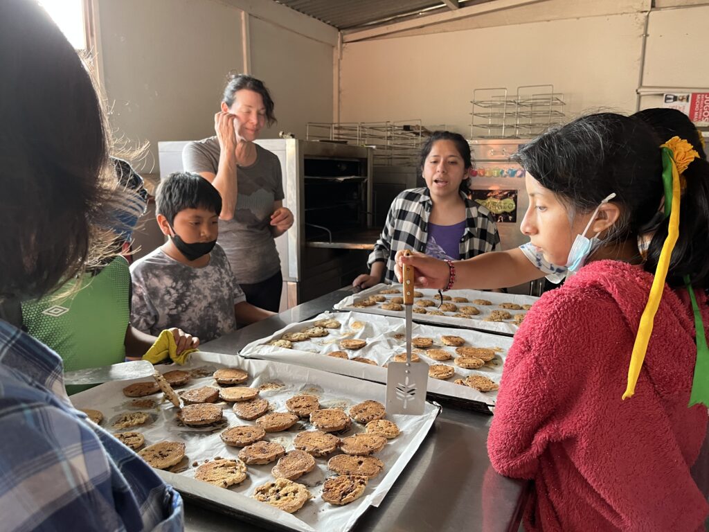 DWC volunteers baking cookies with local children in Peru