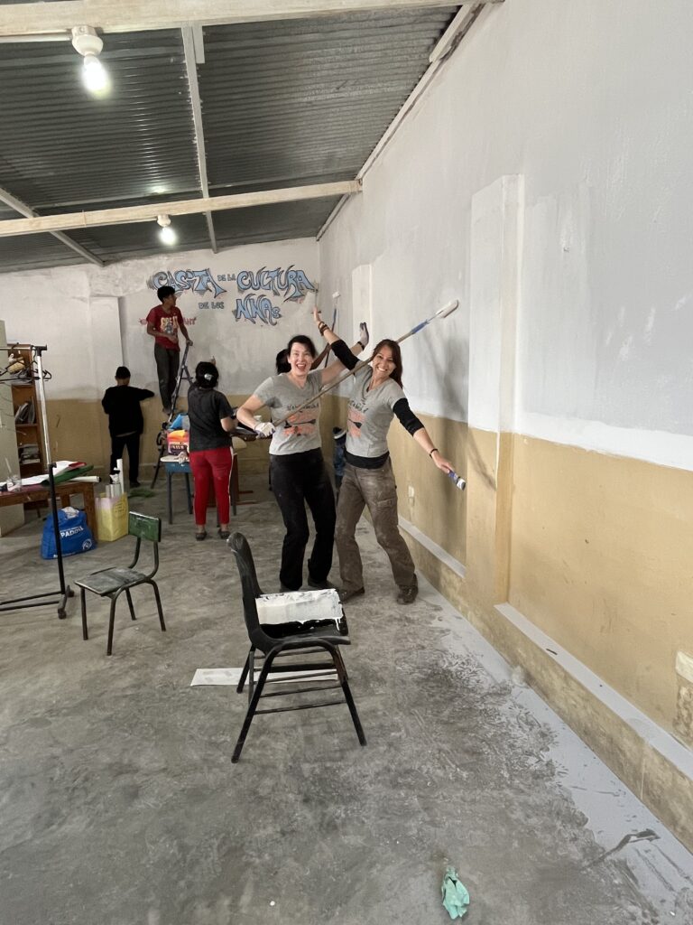 DWC volunteer painting interior of classroom, Lima Peru