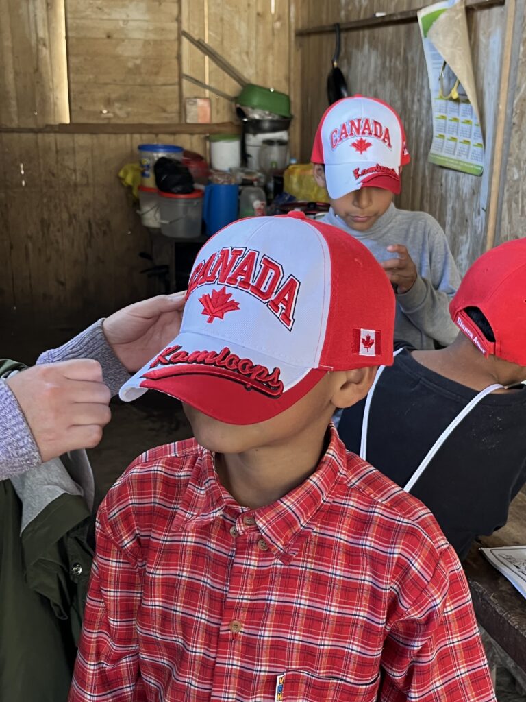 Schoolkids putting on Canada Hats
