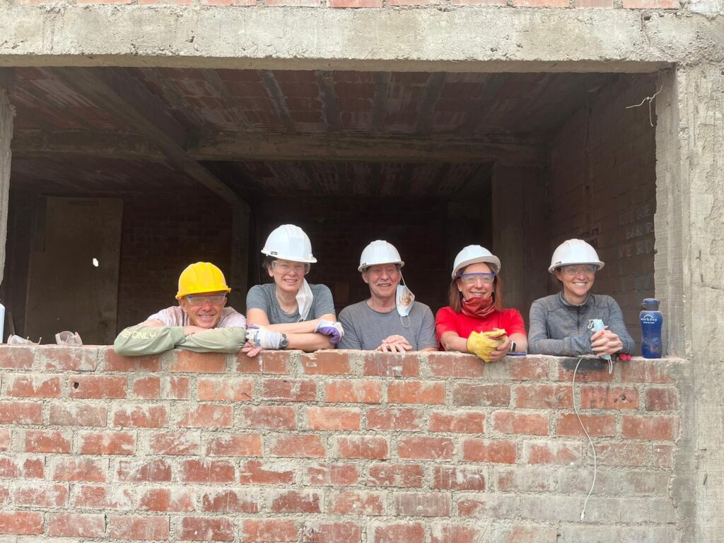 DWC team in Peru overlooking brick wall