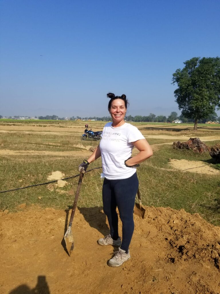 Volunteer standing with shovel nepal