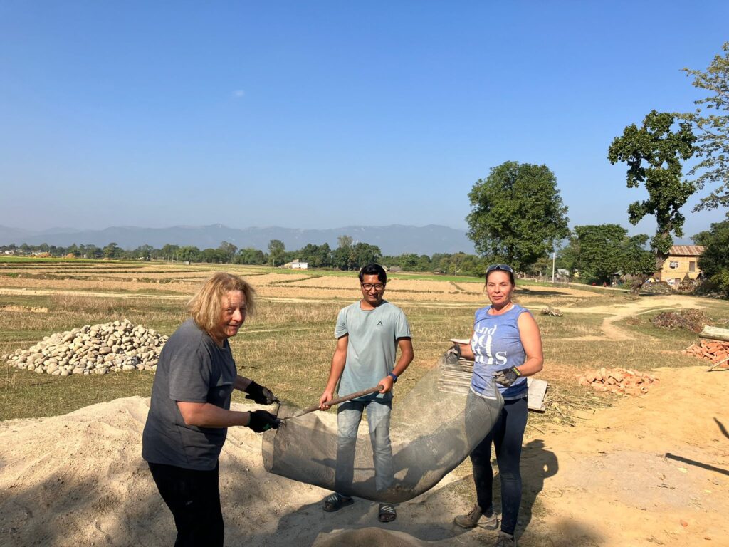 DWC volunteers sifting sand in Nepal