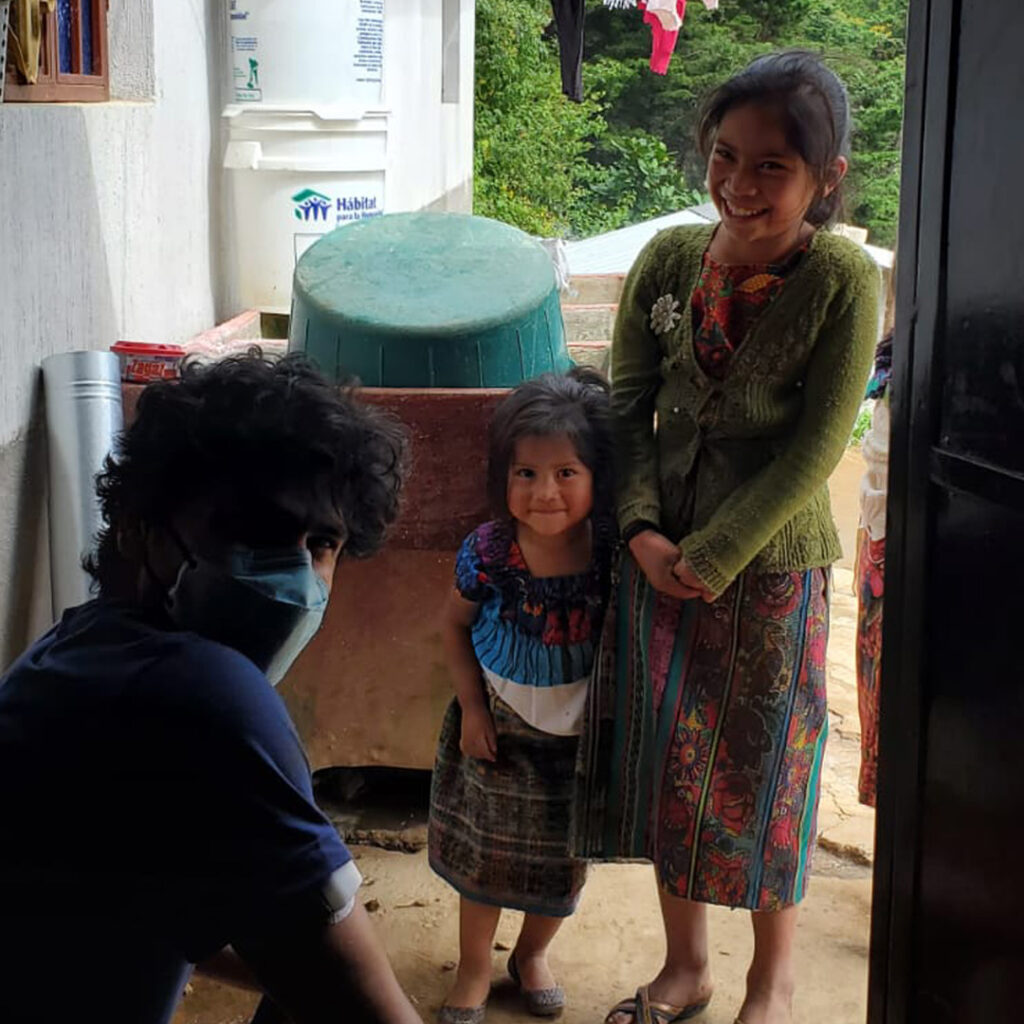 Volunteer in home of Eco stove recipient