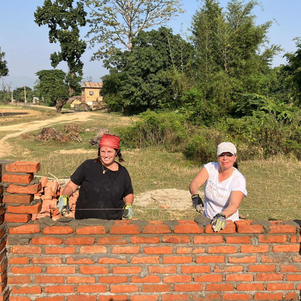 DWC volunteers laying bricks in Nepal