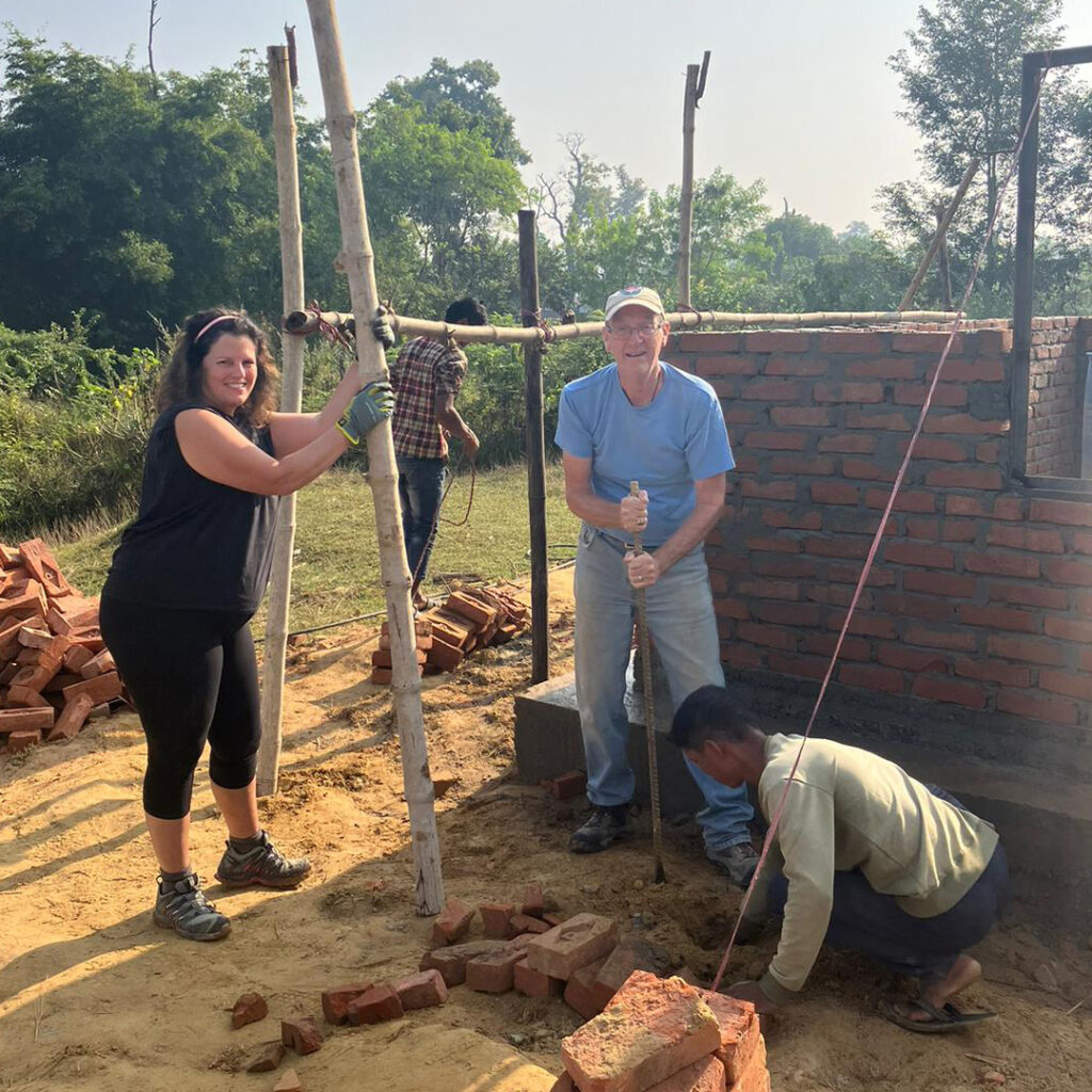 DWC volunteers digging laying a foundation in Nepal