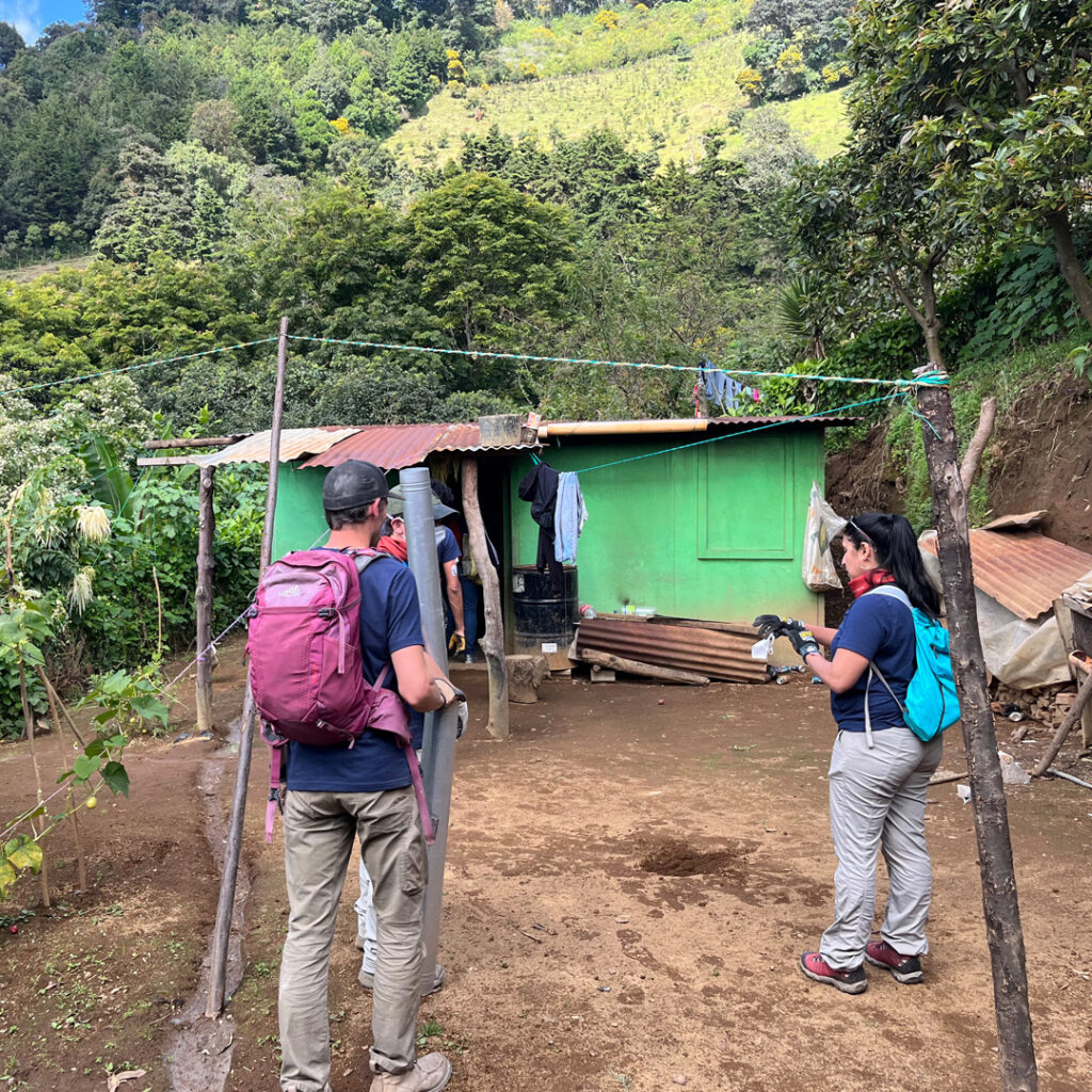Salesforce volunteers outside of a home to install Eco stove in Guatemala