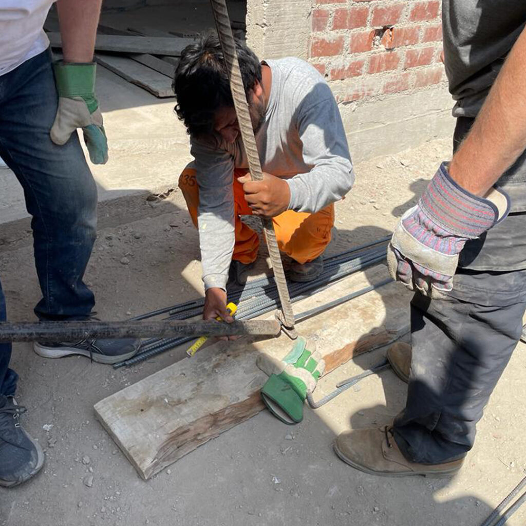 Construction worker in Peru holding rebar