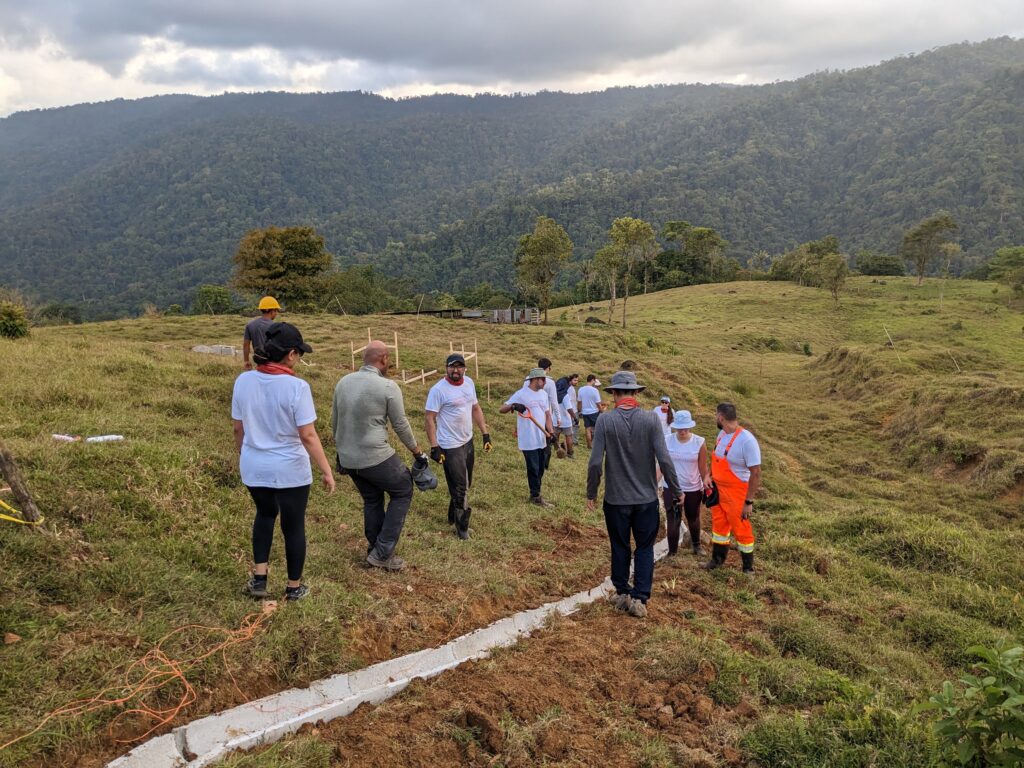 Salesforce volunteers in Costa Rica laying concrete trough