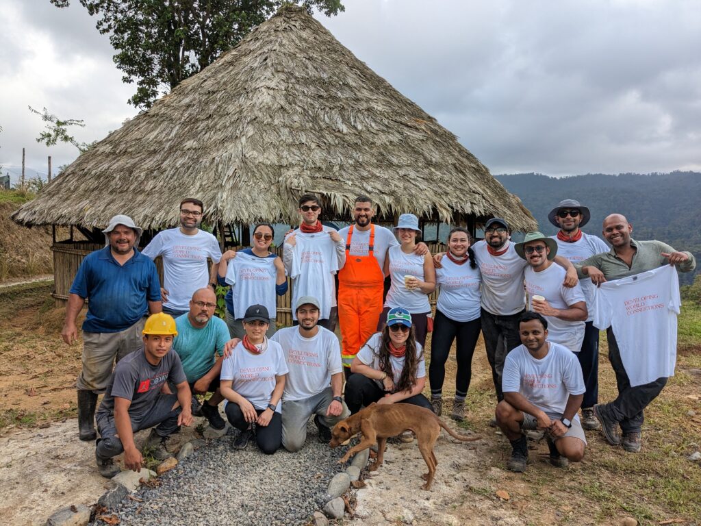 DWC Salesforce volunteer team 3 posing in front of grass hut in Costa Rica