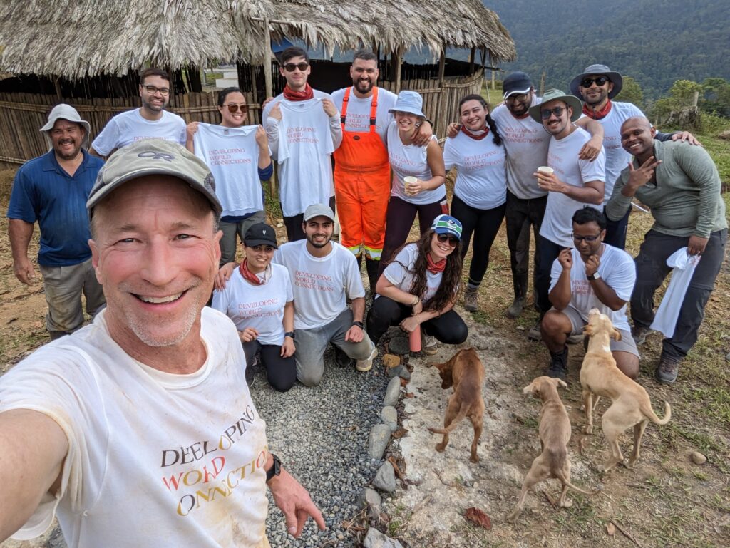 DWC Salesforce volunteer team 3 in front of grass hut in Costa Rica