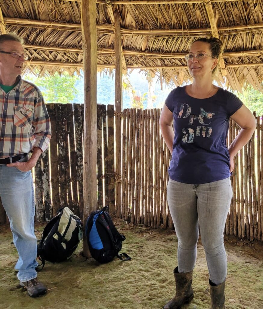 David Lyon and volunteer in grass hut in Costa Rica