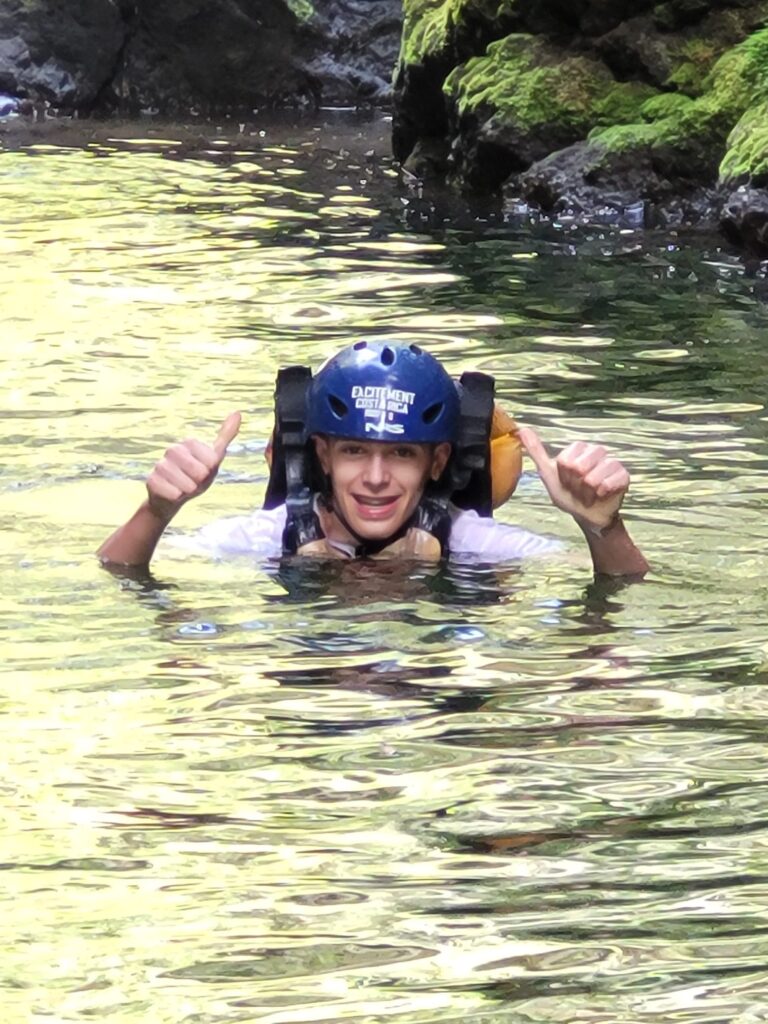 Two thumbs up from Volunteer in river in Costa Rica