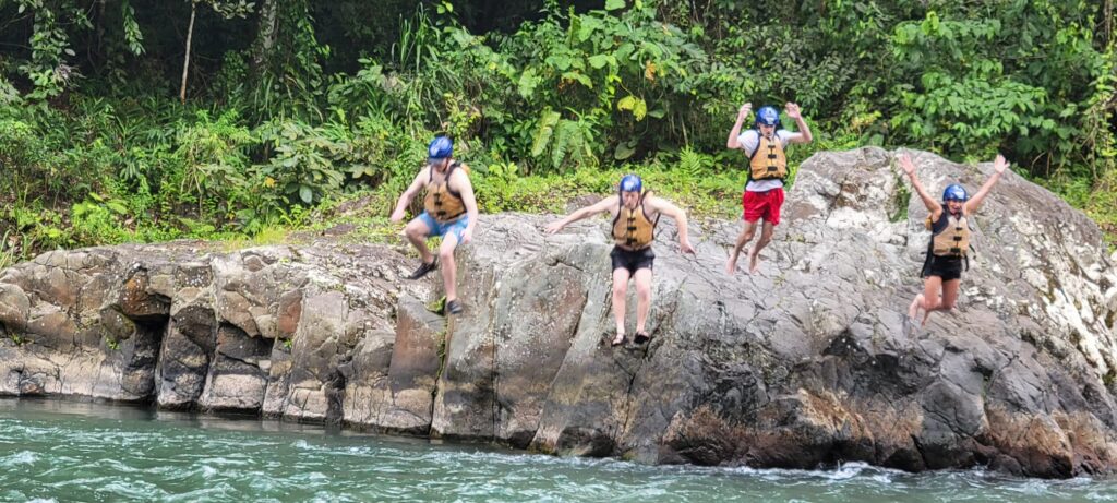 DWC volunteers jumping into river in Costa Rica