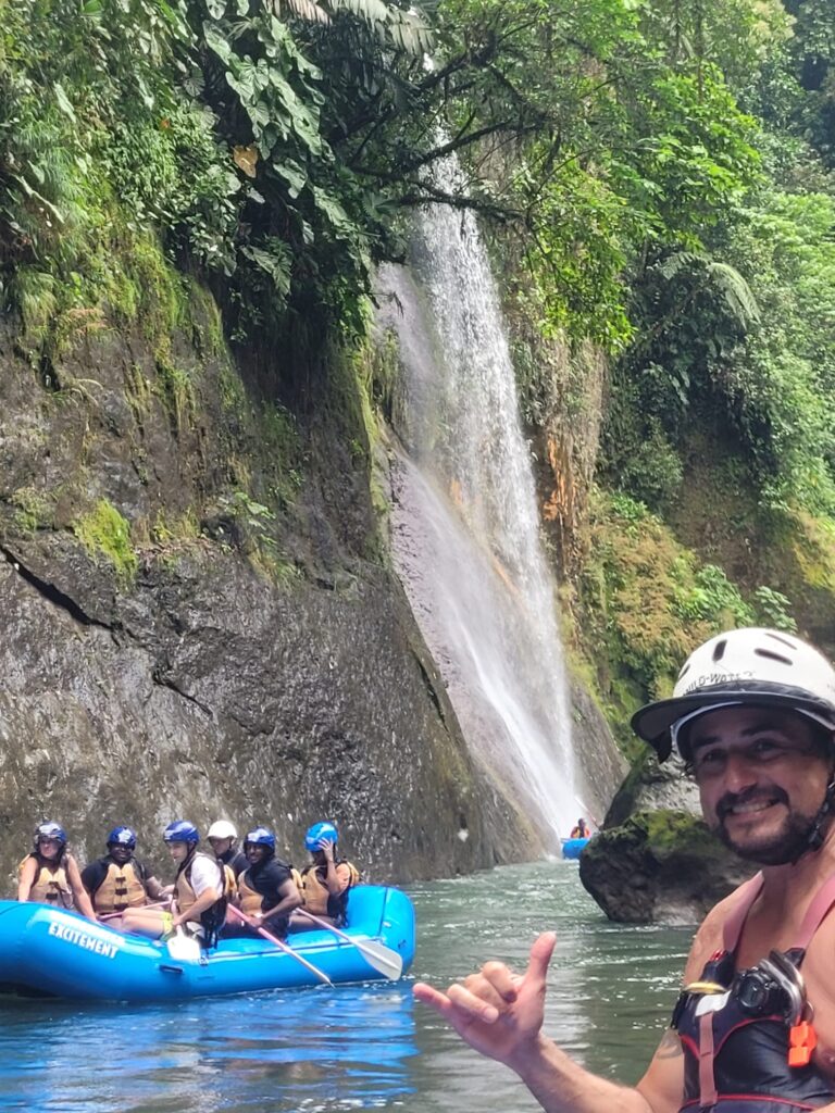 River rafting past waterfall in Costa Rica
