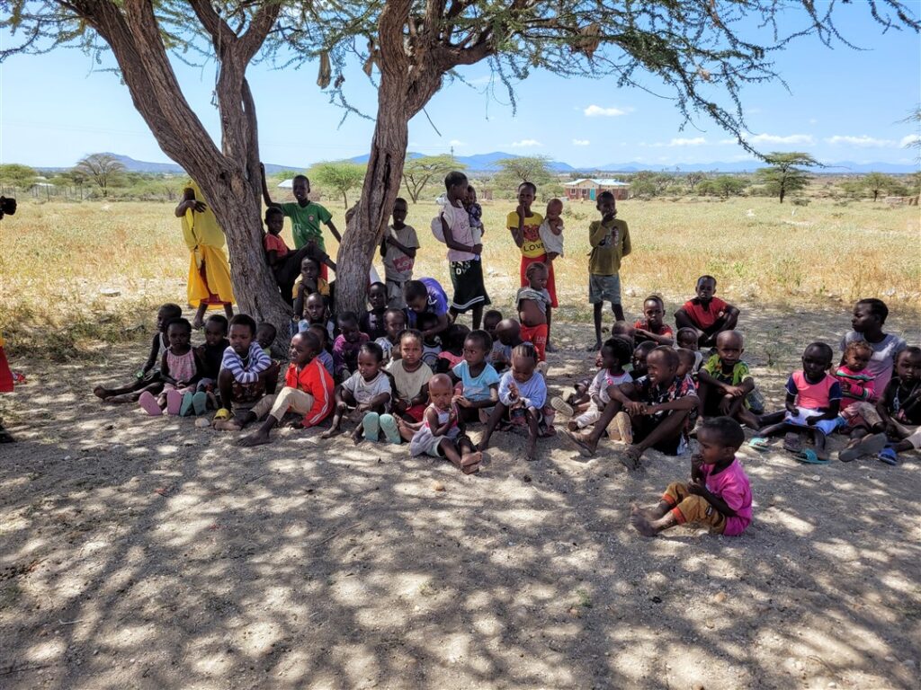 Schoolchildren in Kenya under tree for shade
