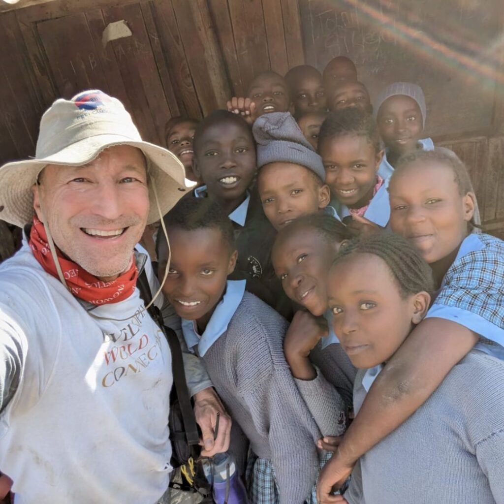 DWC Team Leader with schoolchildren in Kenya