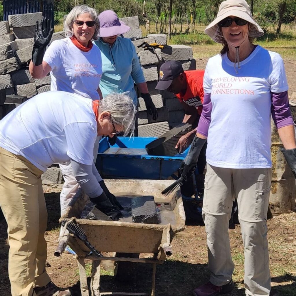 DWC volunteers working with concrete bricks in Kenya