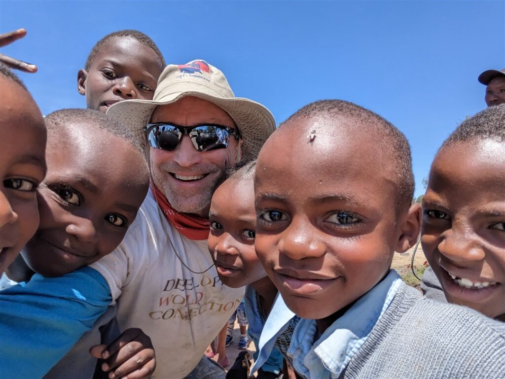 Schoolchildren outside with DWC team leader in Kenya
