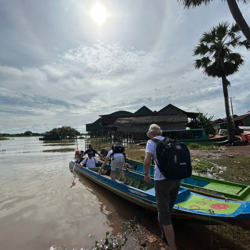 DWC volunteers in a boat in Cambodia
