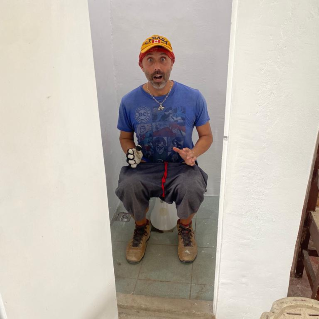 DWC volunteer goofing around on toilet Philippines