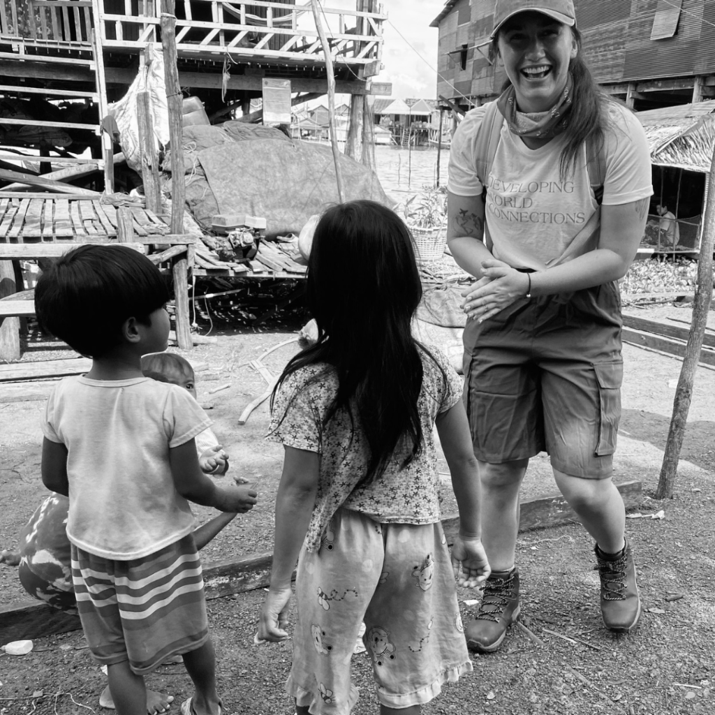 Children with DWC volunteer at project site in Cambodia