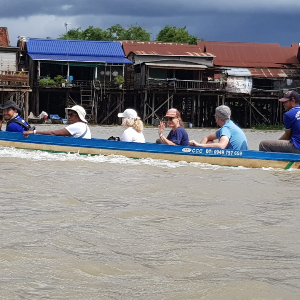 DWC volunteers in river boat Cambodia