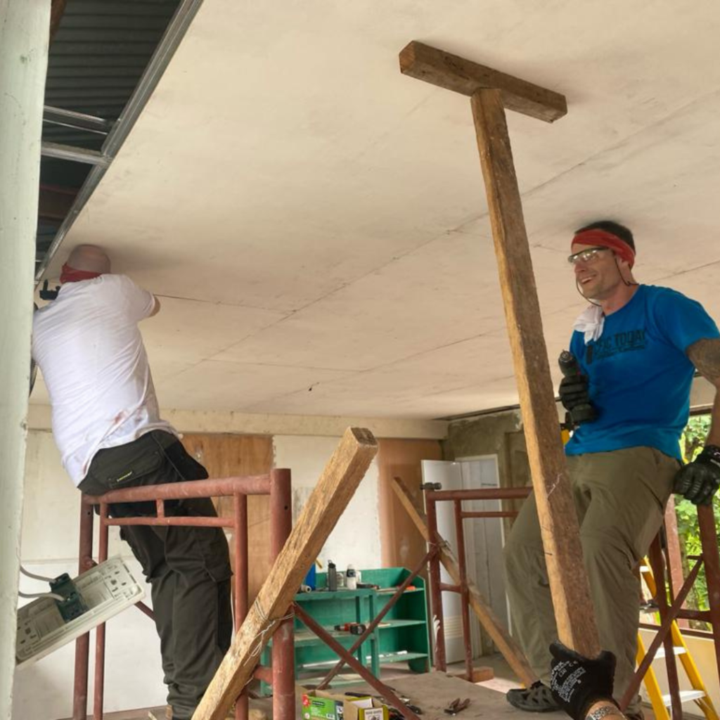 Volunteers installing ceiling drywall Philippines