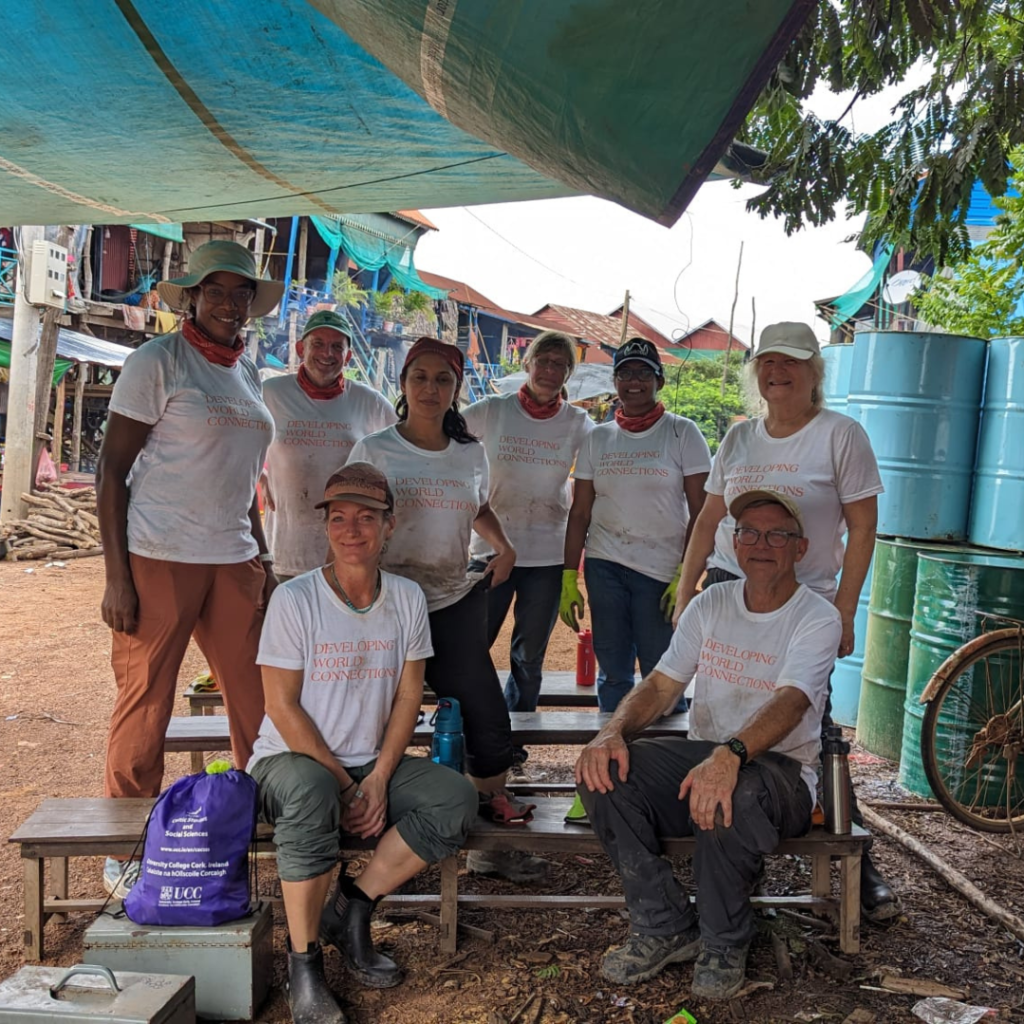 Salesforce volunteers in Cambodia under tarp