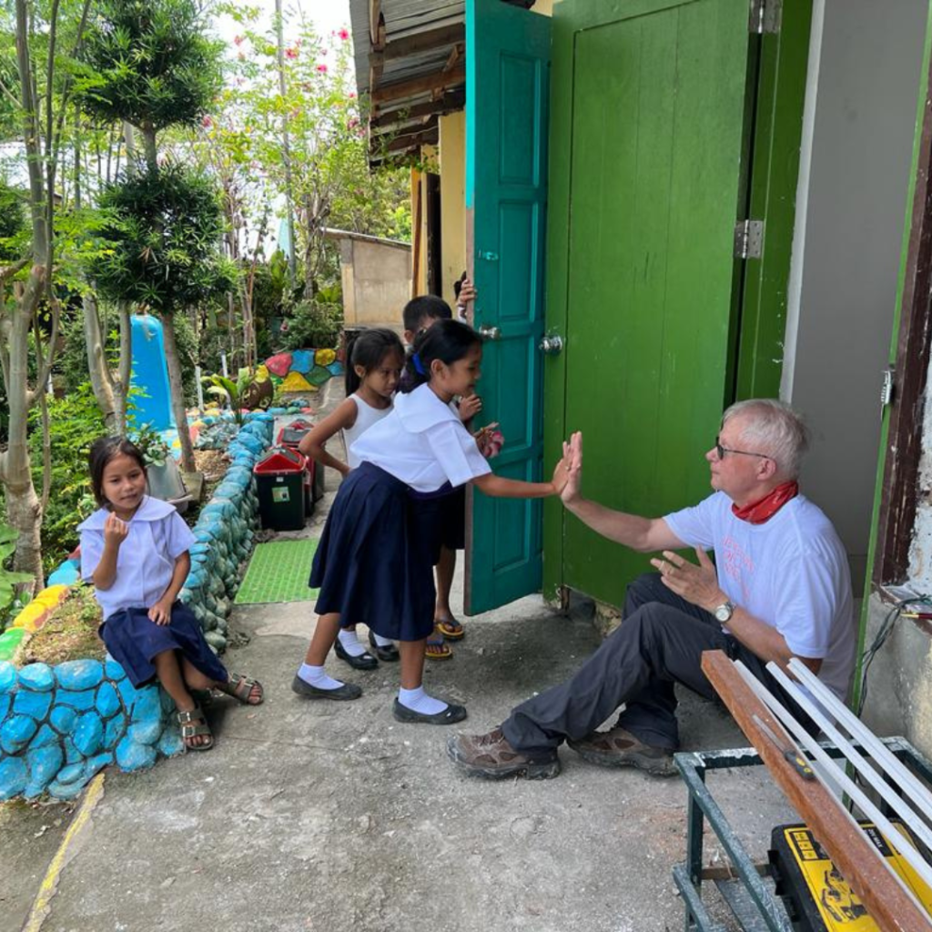 Philippine children outside at door of school