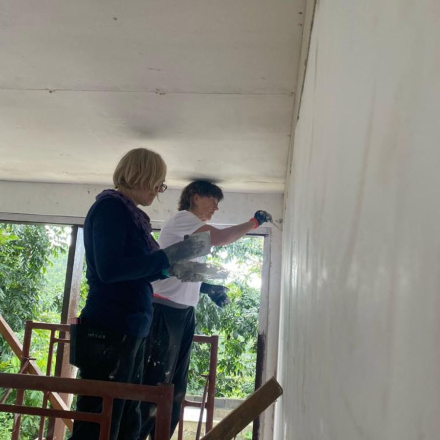 Volunteer painting inside schoolroom Philippines
