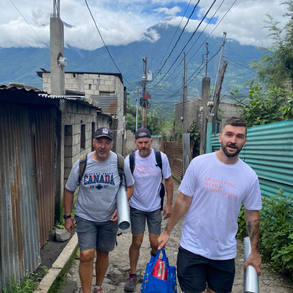 DWC volunteers carrying equipment in Guatemala street