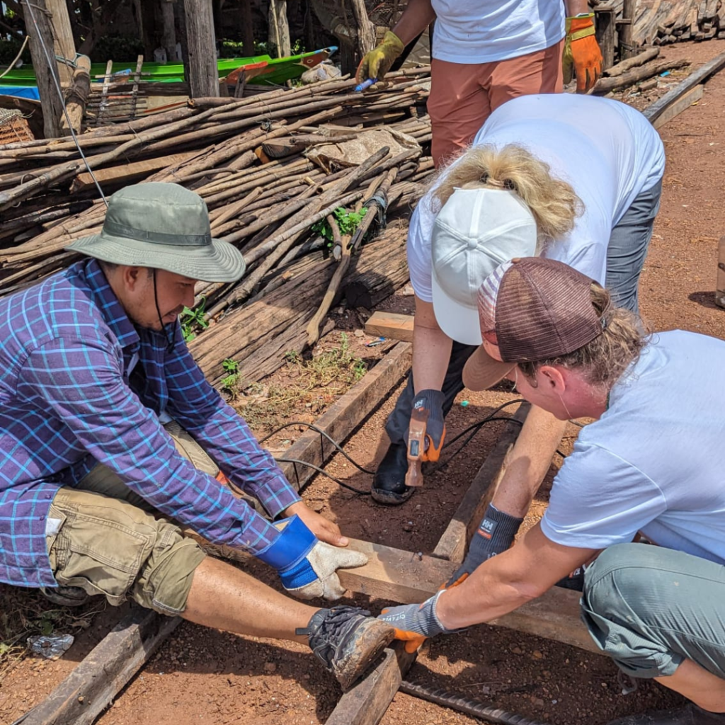 Salesforce volunteers in Cambodia hammer and nails