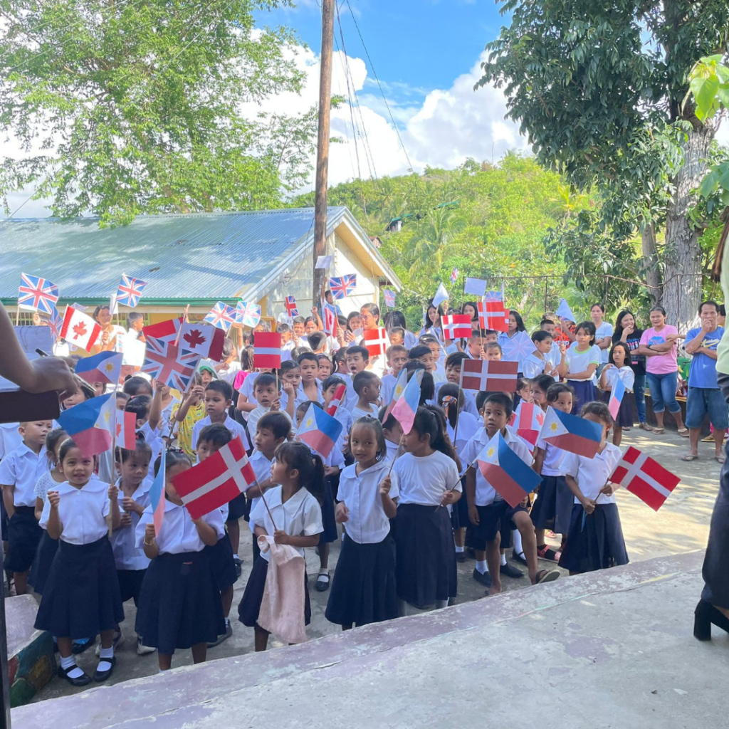 Philippine schoolchildren outside with flags