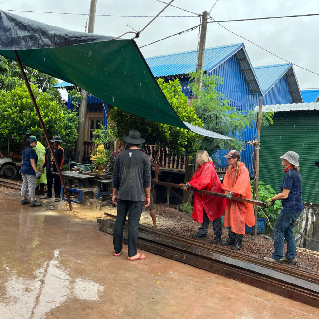 Salesforce volunteers in Cambodia in the rain