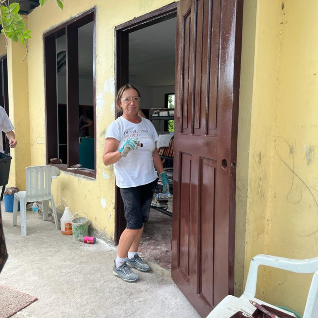 DWC Team Leader, Cindy Logan painting a door at project Philippines