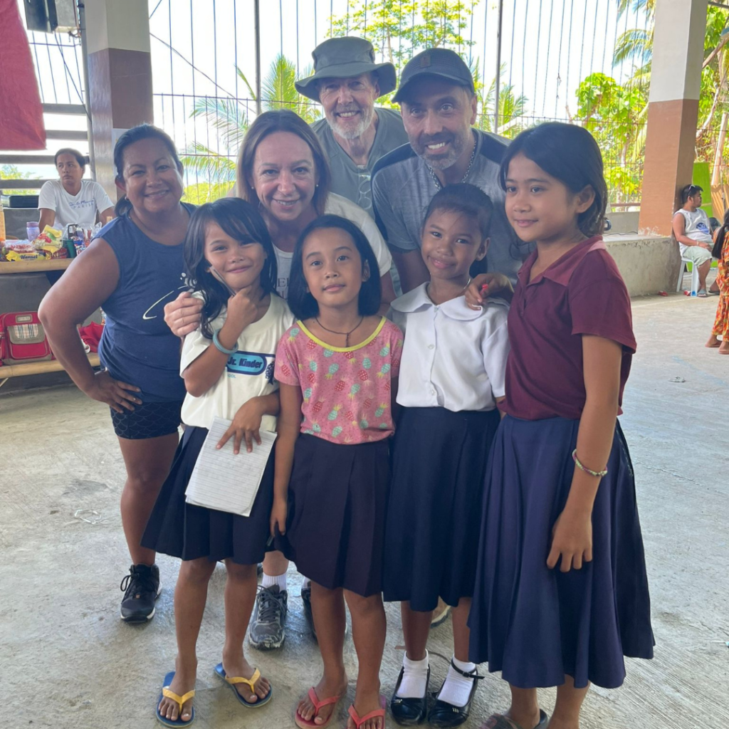 DWC volunteers posing with children Philippines