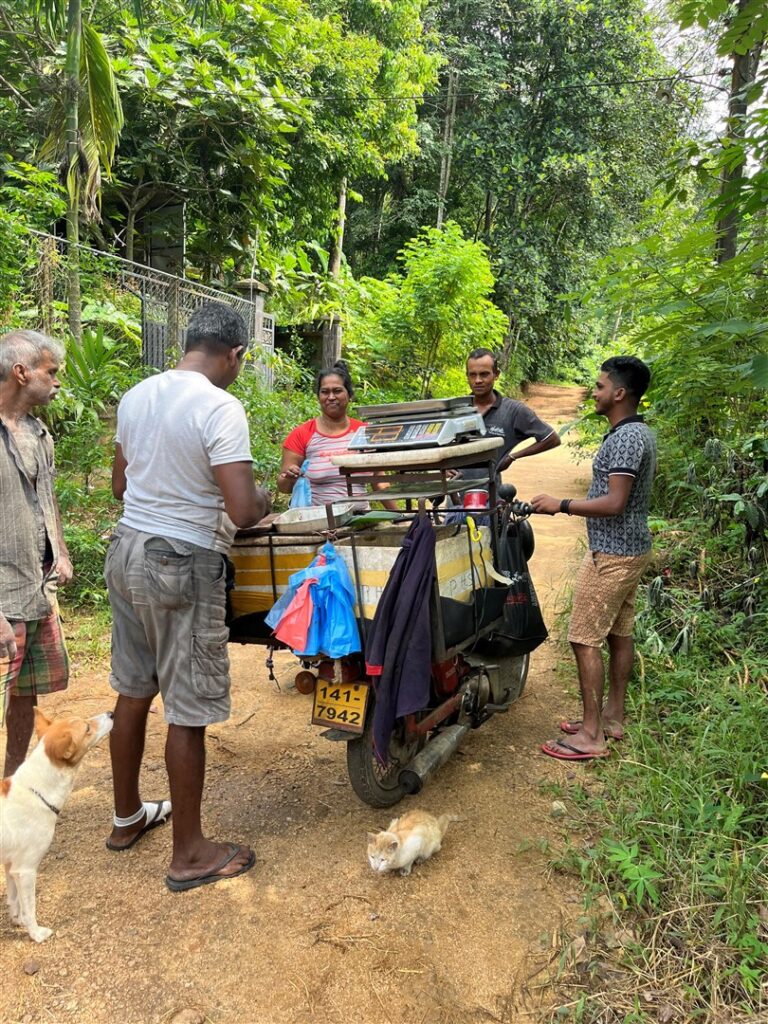 Fishmonger on his motorbike cutting fish to order Sri Lanka
