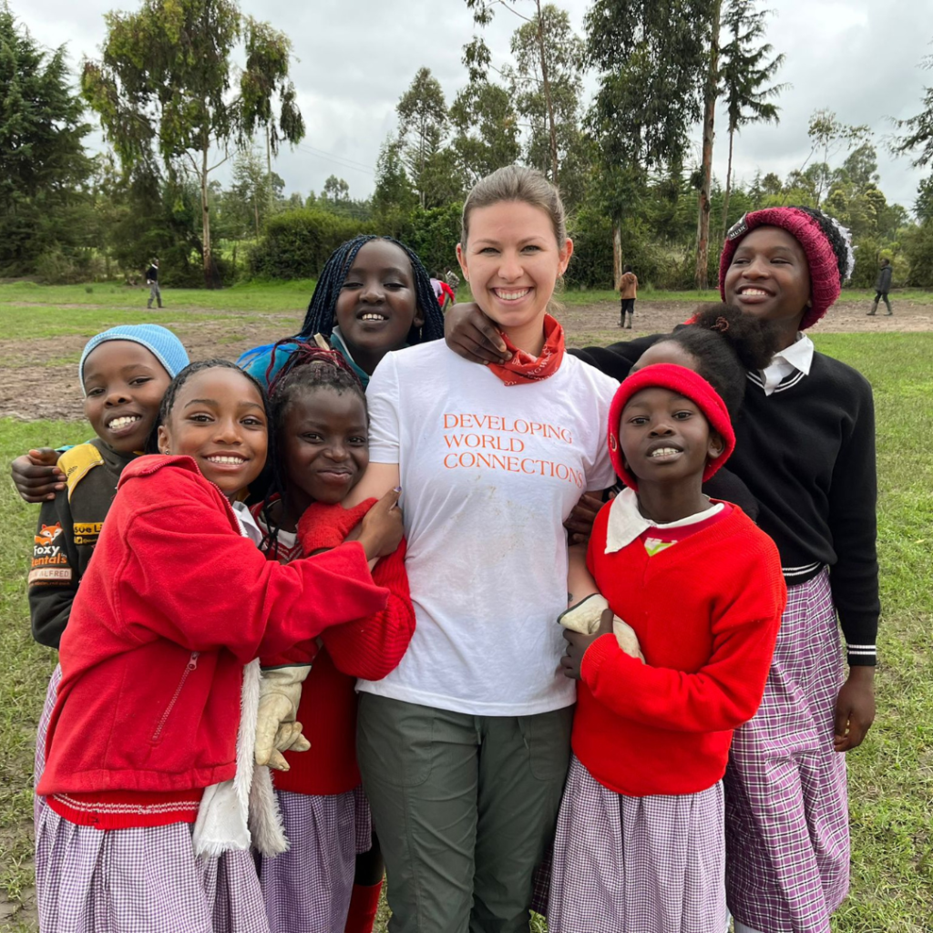 Kenya schoolchildren outside classroom with volunteer