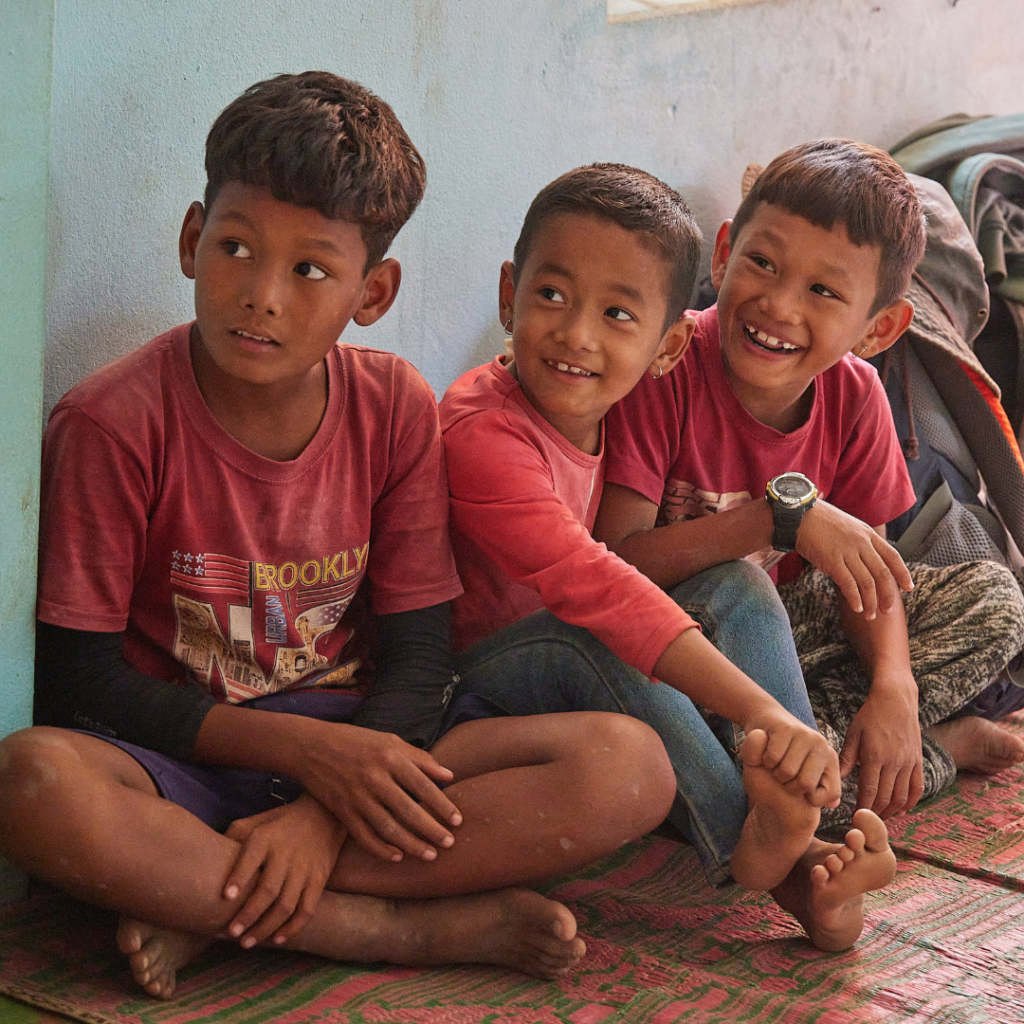 Nepalese children sitting on mats