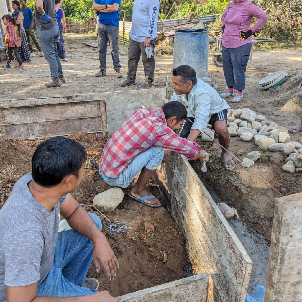 Volunteers at project site with local tradespeople in Nepal