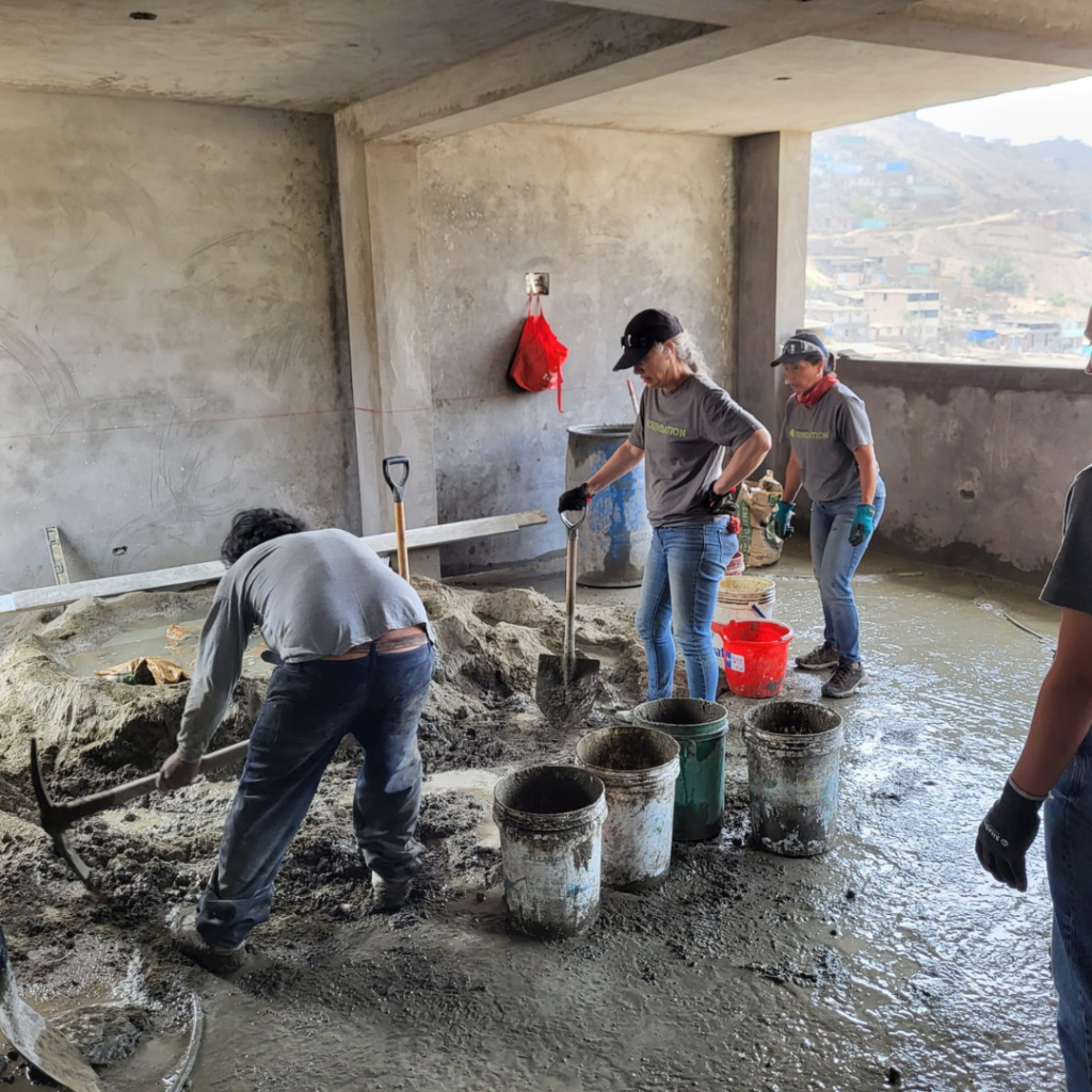 Urban Systems volunteers working in wet cement Peru