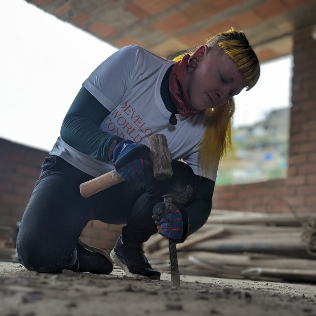 Salesforce volunteer Peru working with hammer and chisel