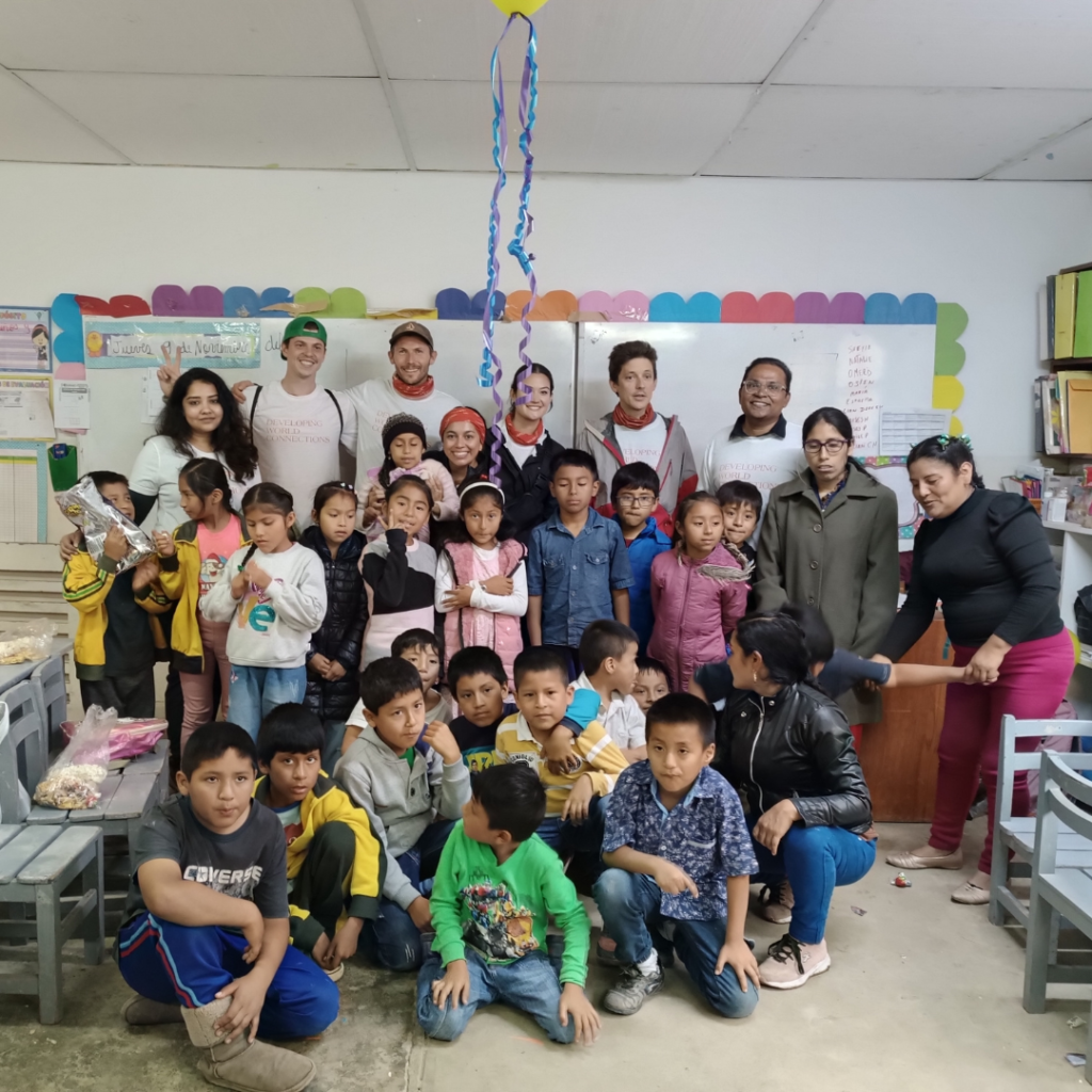 Schoolchildren and volunteers inside classroom Peru