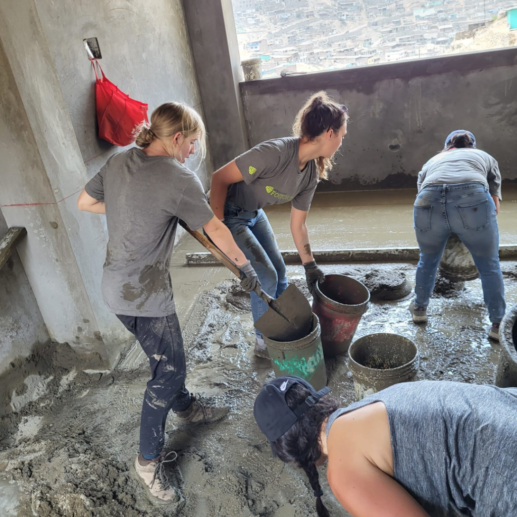 Urban Systems volunteers working in wet cement Peru