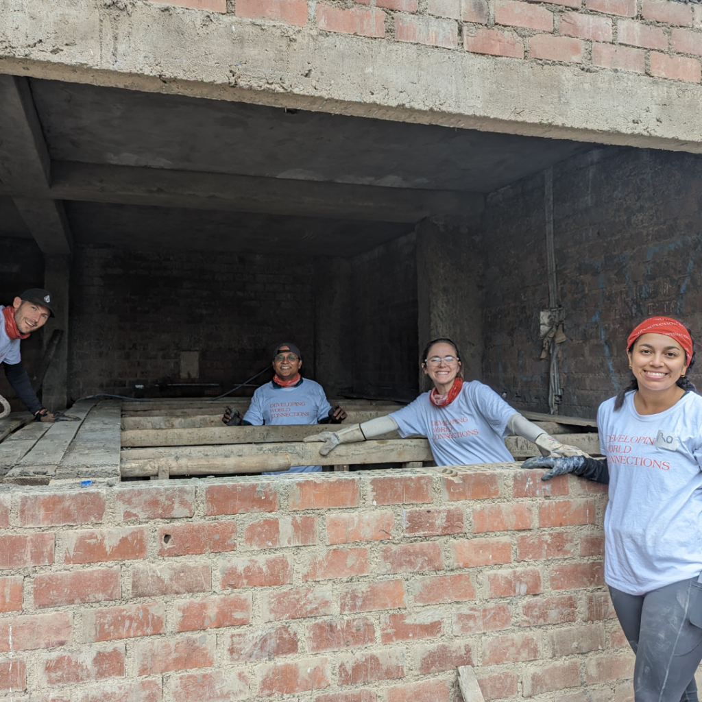 Salesforce volunteers building brick walls Peru