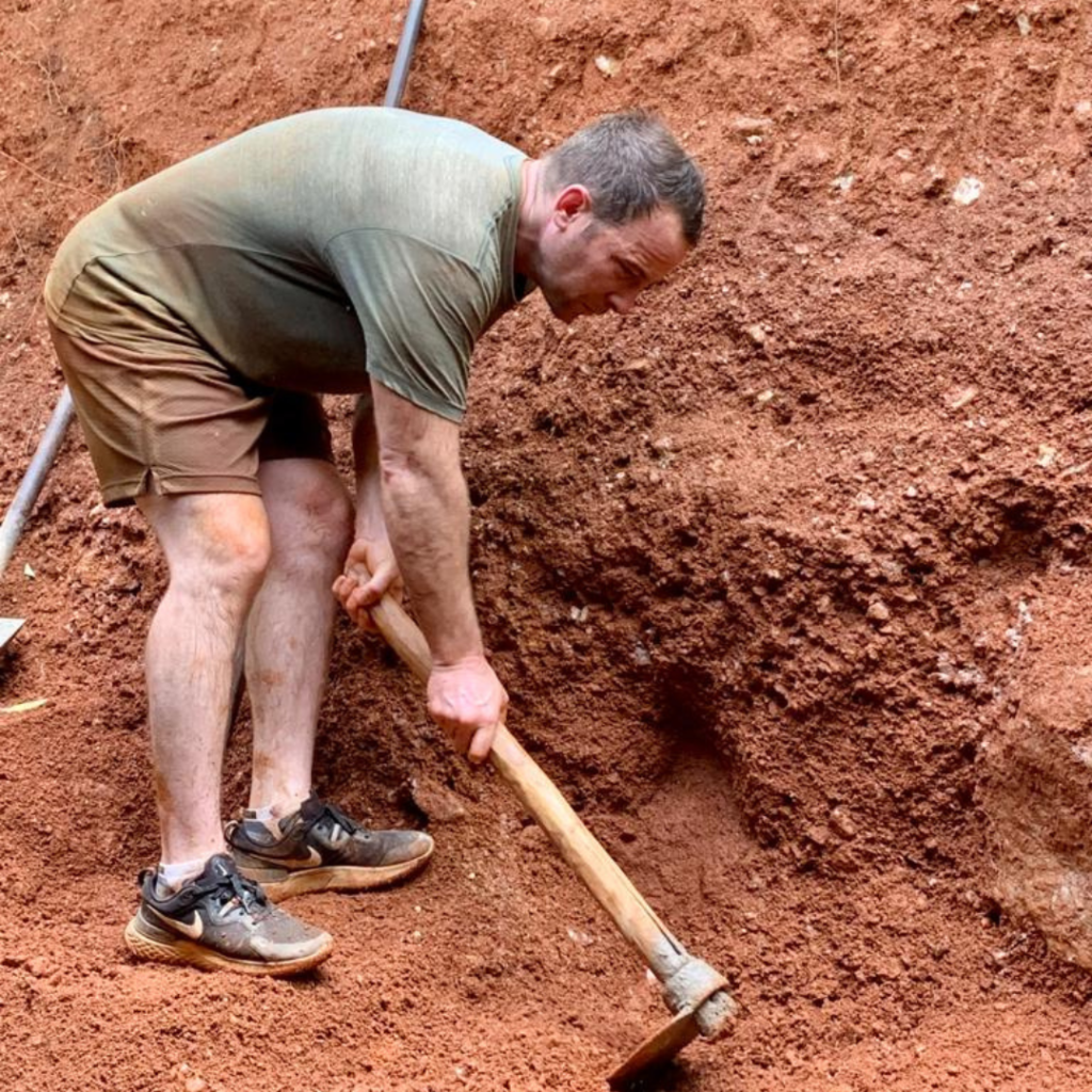 Volunteer in Sri Lanka digging with hoe