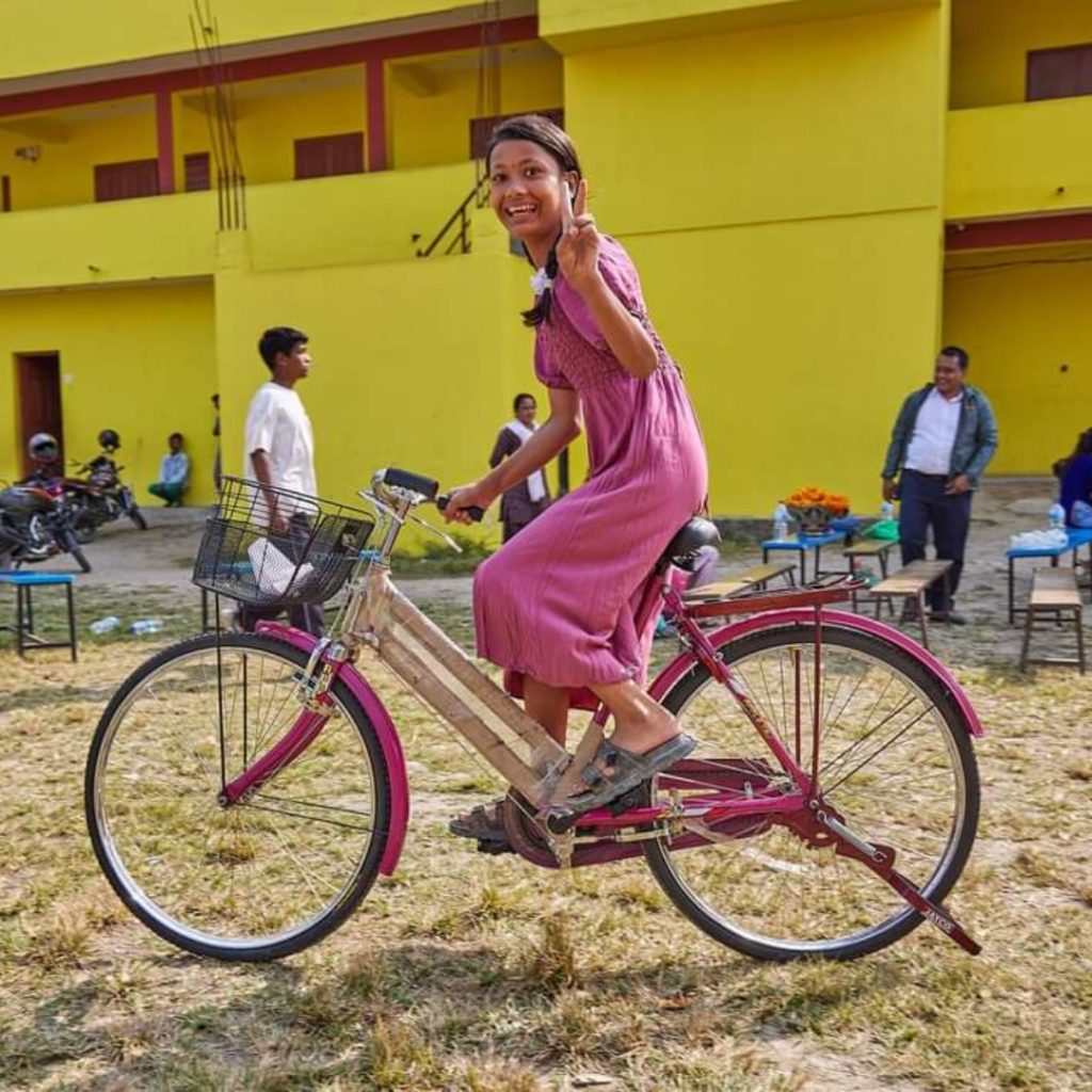 Young Nepalese girl riding bicycle