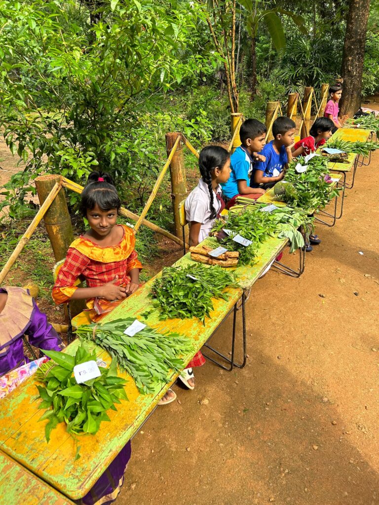 Sri Lankan children selling vegetables on table
