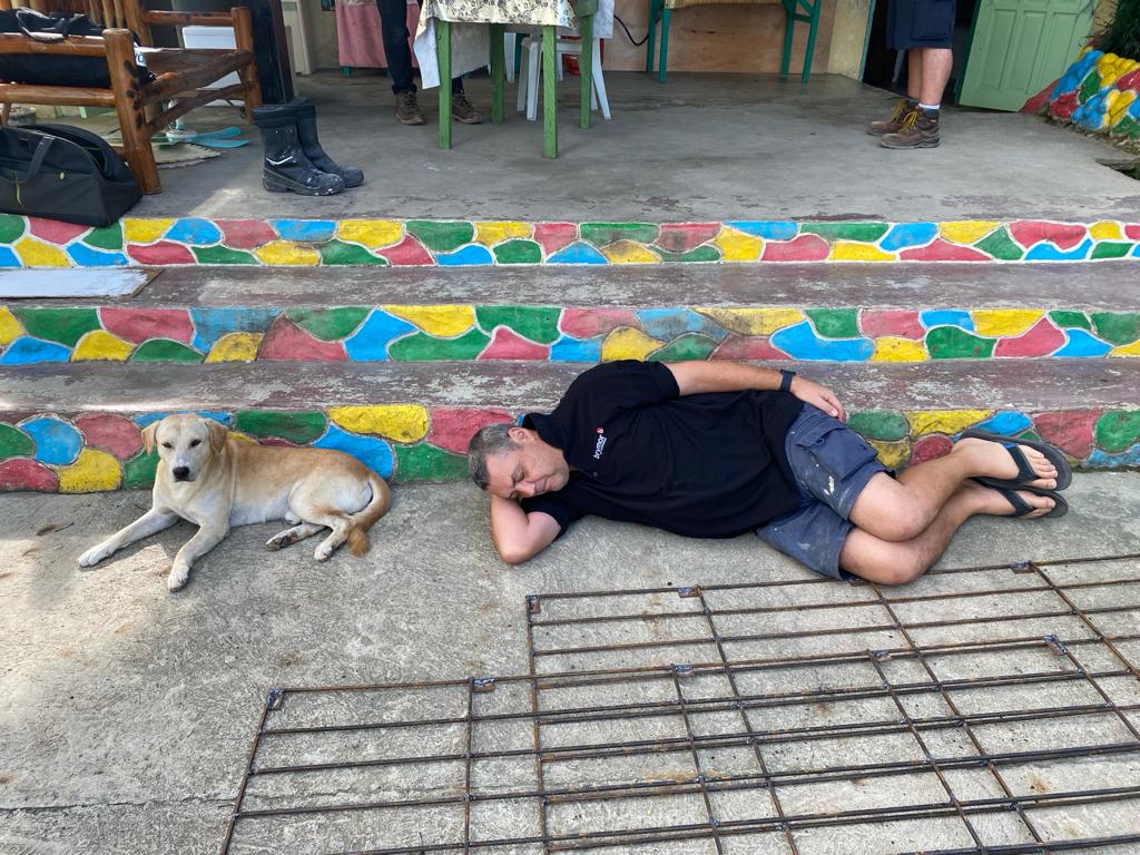 Volunteer sleeping beside dog Philippines